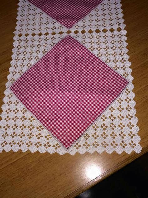 Two Red And White Placemats Sitting On Top Of A Wooden Table Next To