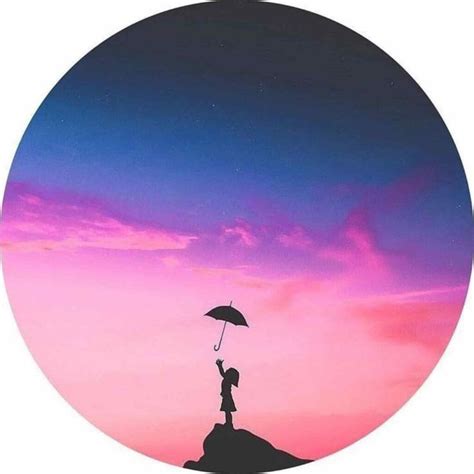 A Person Holding An Umbrella While Standing On Top Of A Hill At Sunset