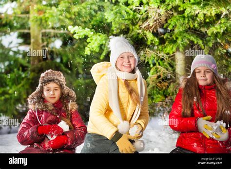 Three Girls Snowball Fighting In The Winter Forest Stock Photo Alamy