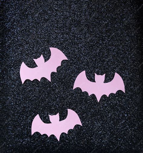 Premium Photo | Pink paper bats on a black glitter background halloween ...