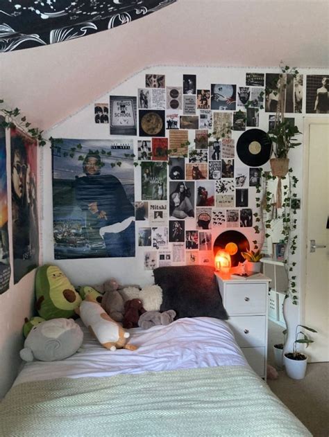 there is a bed with many pictures on the wall