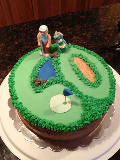 A Golf Themed Cake On A White Plate With Green Frosting And Decorations