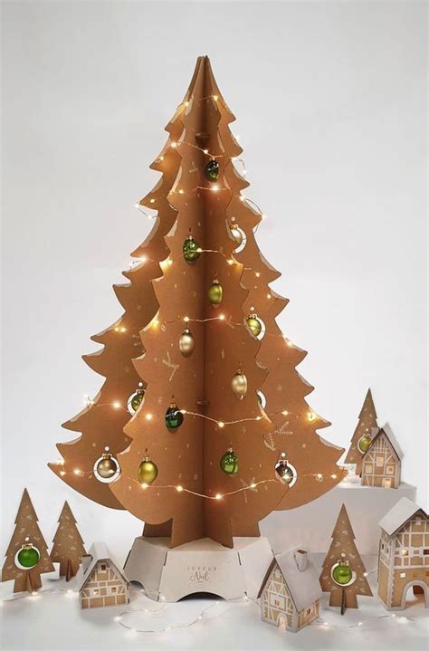 A Wooden Christmas Tree Surrounded By Small Houses And Trees With