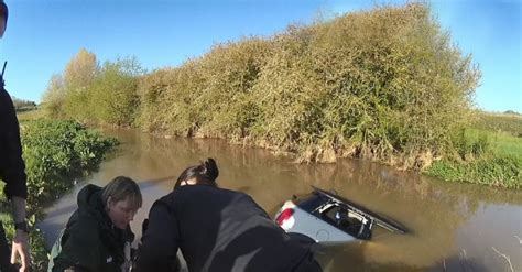 Police Officers Save Woman Stranded In Her Car From Flooded Ford