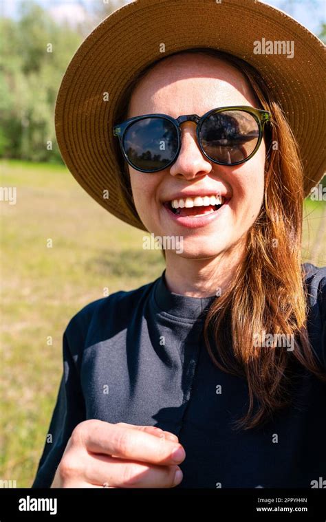 Stylish Woman With Sunglasses And Straw Hat Laughing And Taking A