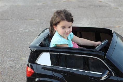 Two Amazing Girls Ride in One Big Toy Car on City Street Asphalt ...