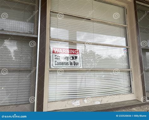 Camera in Use Sign in a Window of a Home Stock Photo - Image of yellow ...