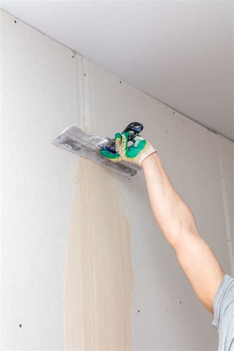 A Worker Is Plastering A Wall With A Plastering Tool Stock Image