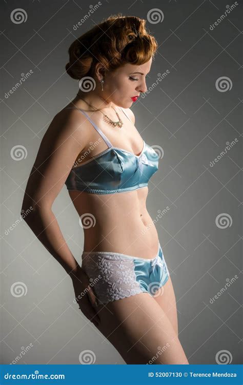 Stunning Redhead With Vintage Hairstyle Wearing Blue Satin Lingerie