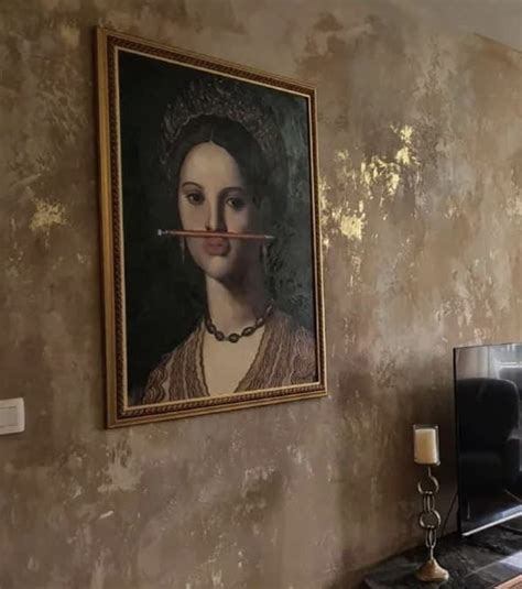 A Living Room With A Painting On The Wall