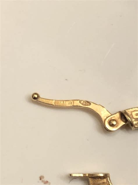 Is anyone able to help me identify these markings on earrings and what