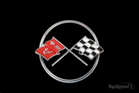 The Emblem On A Car With Checkered Flags In Front Of A Black Background