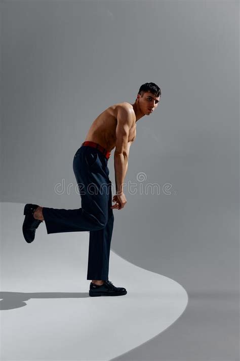 Man With A Naked Torso In Jeans And Shoes On A Gray Background Stock Photo Image Of