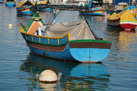 Premium Photo Malta Colorful Painted Fishing Boat In Marsaxlokk Village