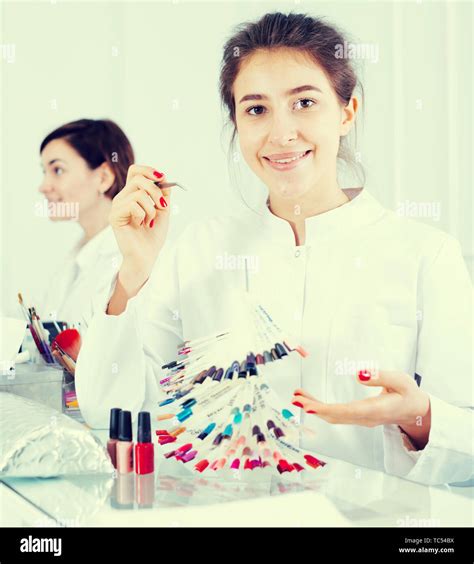 Pretty Woman Doing Nails Displaying Polish Color Schemes In Nail Salon