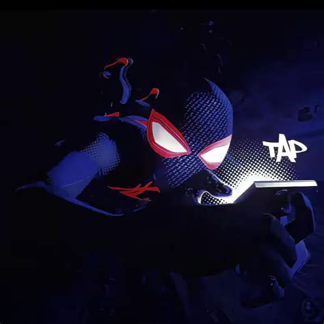 The Spider Man Mask Is Lit Up In The Dark With Red And Blue Lights