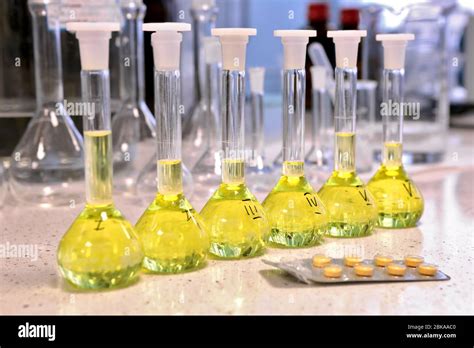 Conducting A Chemical Experiment In A Laboratory Colored Flasks With