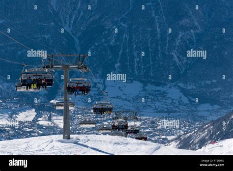 A Chairlift Is Carrying Skiers Up To The Belalp Ski Resort In