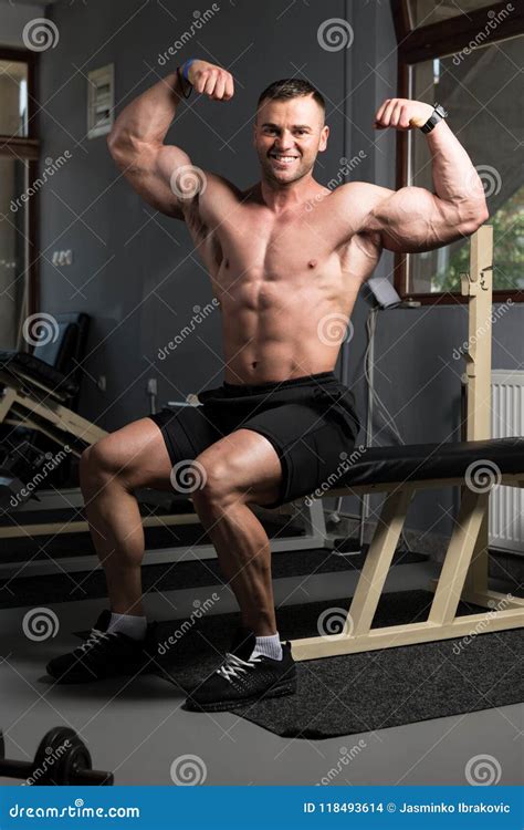 Biceps Pose Of A Young Man In Gym Stock Photo Image Of Muscle Male