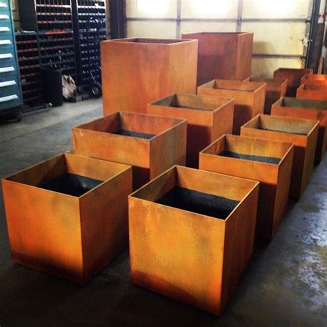 A Batch Of Corten Steel Planter Boxes With A Rust Patina By