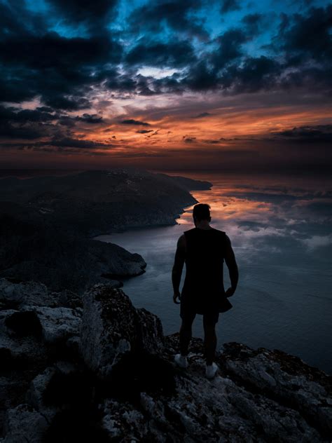 Photo Of Man Standing On Cliff · Free Stock Photo