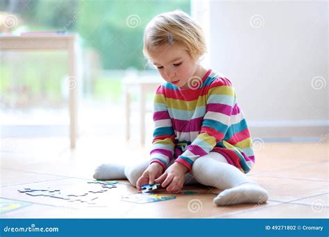 Little Girl Playing with Jigsaw Puzzle Stock Photo - Image of kindergarten, adorable: 49271802