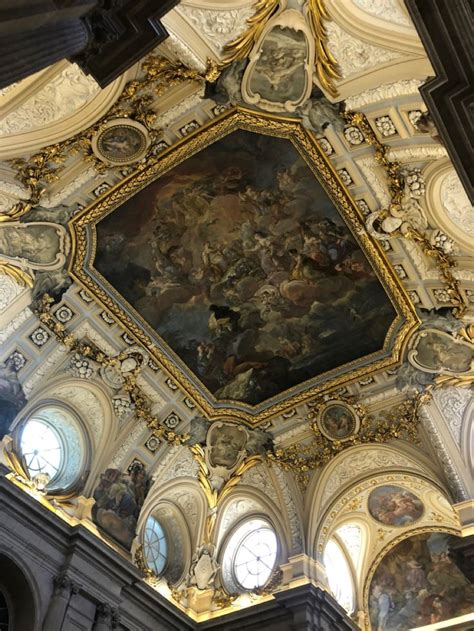 an ornate painting on the ceiling of a building