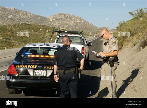 A Local Police Officer Assists A California Highway Patrol Officer On A