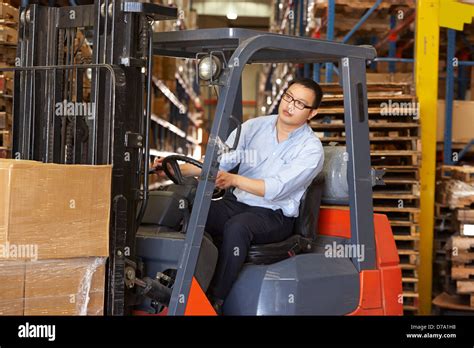 Man Driving Fork Lift Truck In Warehouse Stock Photo Alamy