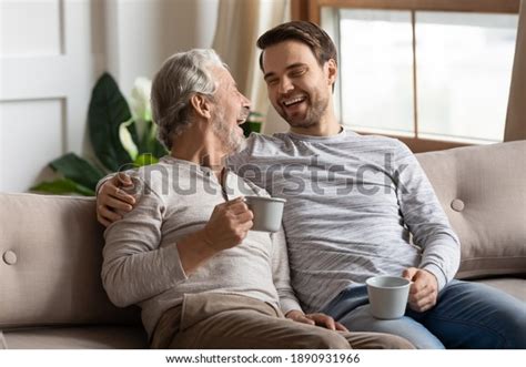 Overjoyed Mature Father Adult Son Sit Stock Photo 1890931966 Shutterstock