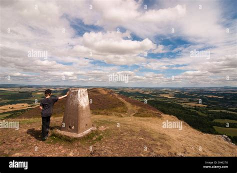 Boy Standing By Trig Point On The Middle Eildon Melrose Stock Photo