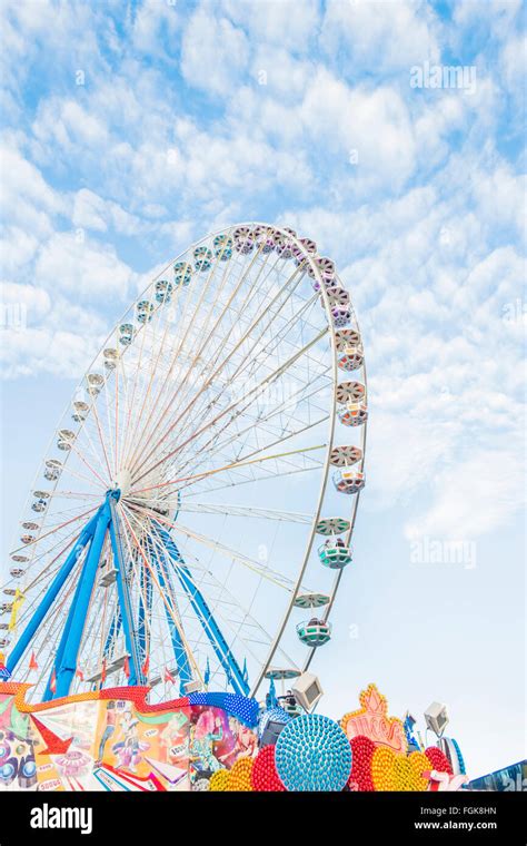 Colorful Neon Signs And Ferris Wheel At Traveling Funfair Stock Photo