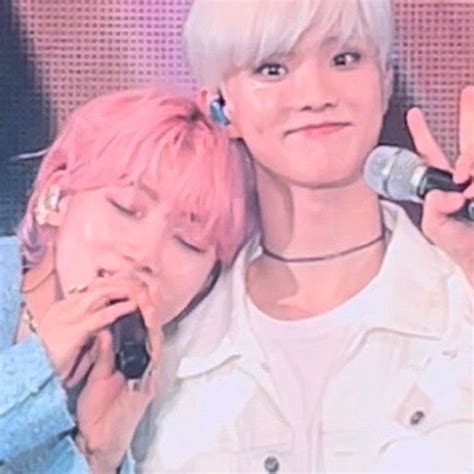 Two People With Pink Hair Are Holding Microphones And Posing For The