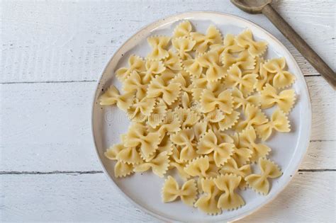 Cooked Farfalle Or Bow Tie Pasta On A Plate On White Background Stock