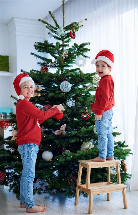 Happy Kids Decorating The Christmas Tree At Home Stock Image Image Of