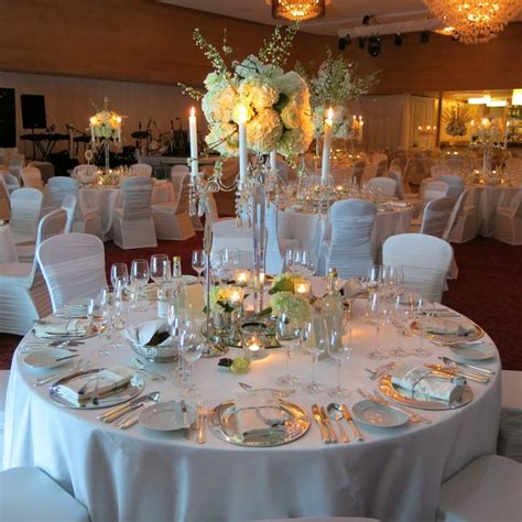 White Cotton Linens With Silver Charger Plates White Wedding Table