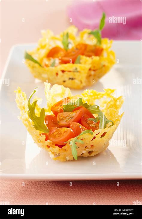 Rocket Lettuce And Cherry Tomato Salad Served In Parmesan Tuile Casings