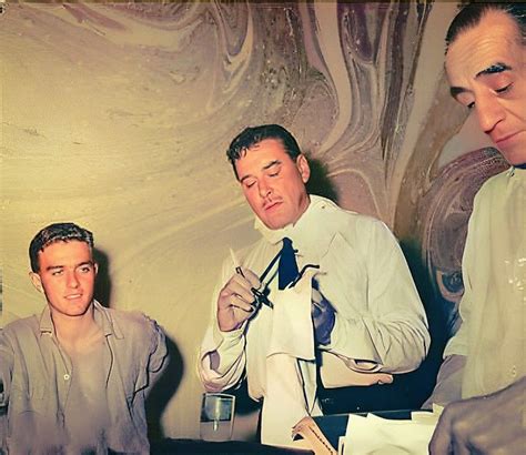 Black And White Photograph Of Three Men At A Table