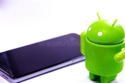 Green Plastic Android Figure on a White Background and with a ...