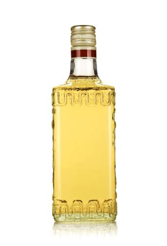 Generic Bottle Of Gold Tequila On A White Surface Stock Photo