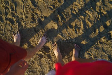 Top View On Naked Feet On Sand In Foaming Sea Wave Stock Photo Image