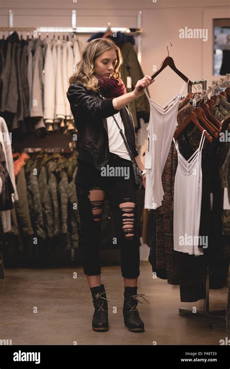 Beautiful Woman Selecting Clothes From Rack Stock Photo Alamy