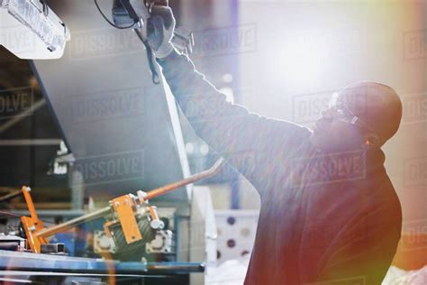 Worker Operating Machinery In Steel Factory Stock Photo Dissolve