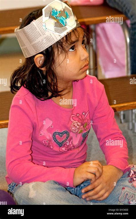 Asian American First Grade Female Student Part Of A Classroom Recycling