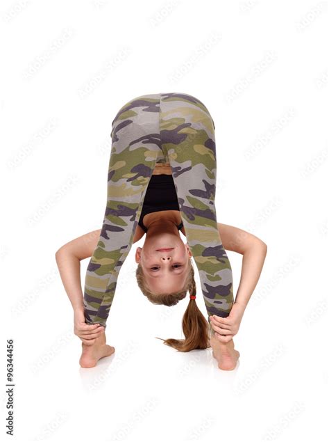 Active little girl doing yoga exercise Stock Photo | Adobe Stock