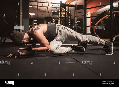 A Sporty Man In The Gym Is Doing Yoga Exercises Push Up Alternative