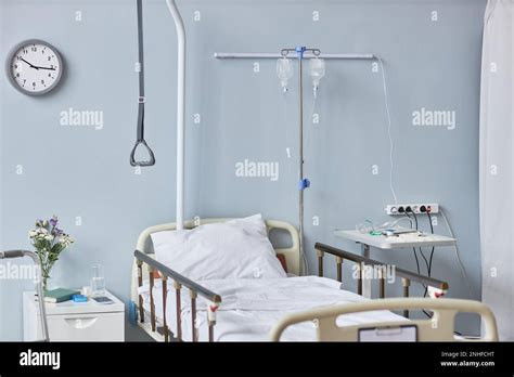 Background Image Of Hospital Room Interior With Bed Against Pale Blue