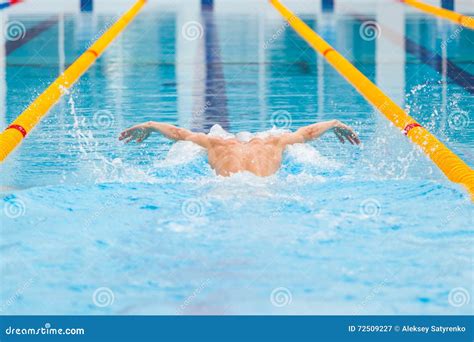 Dynamic and Fit Swimmer in Cap Breathing Performing the Butterfly Stroke Stock Image - Image of ...