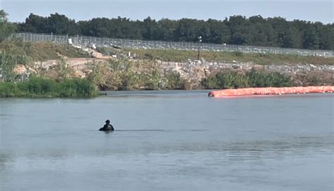 Migrants undeterred by Rio Grande buoys, barbwire, soldiers