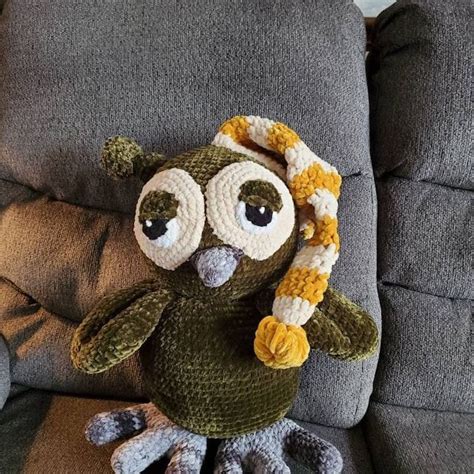 A Crocheted Owl Sitting On Top Of A Couch